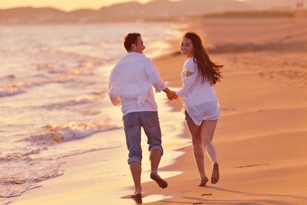 heureux jeune couple romantique amoureux s'amuser sur la belle plage à la belle journée d'été