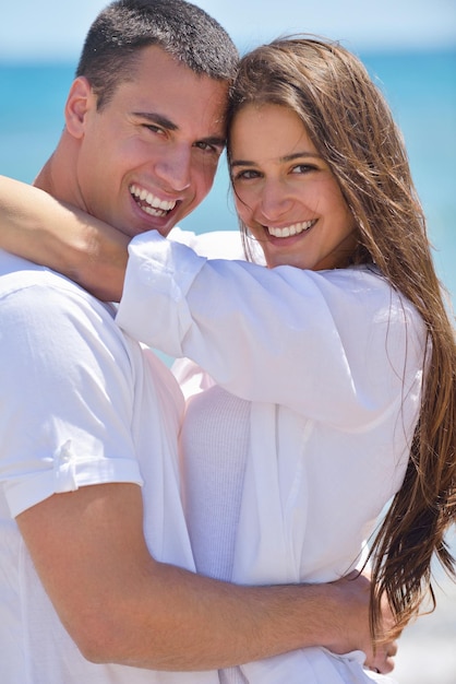 heureux jeune couple s'amuser et se détendre sur la plage