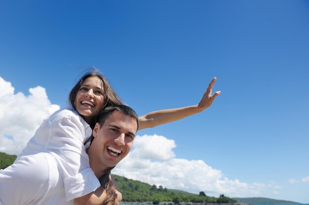 heureux jeune couple s'amuser et se détendre sur la plage