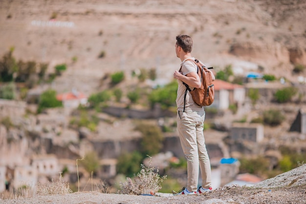 Heureux jeune homme regardant des montgolfières en cappadoce turquie