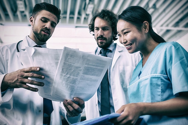 Heureux médecins et infirmière discutant de rapports médicaux