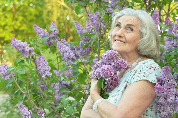 Heureux senior belle femme avec des lilas