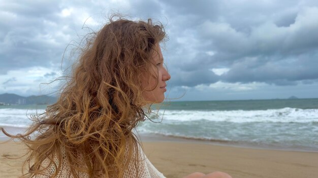 Heureux sérieux triste contrarié fille calme jeune pensive réfléchie femme détendue pensant tout en marchant sur la plage mer pendant les vacances d'été