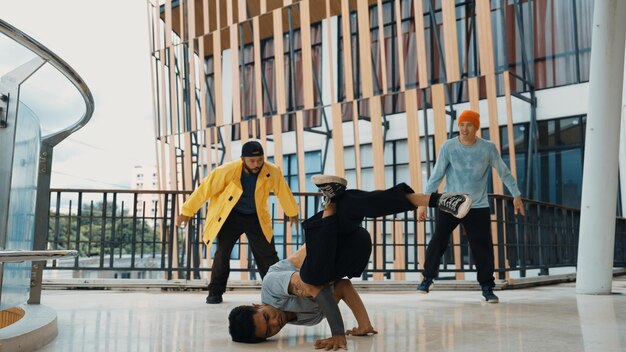 Photo hip hop équipe de danse break dance tandis que l'ami multiculturel entoure l'effort