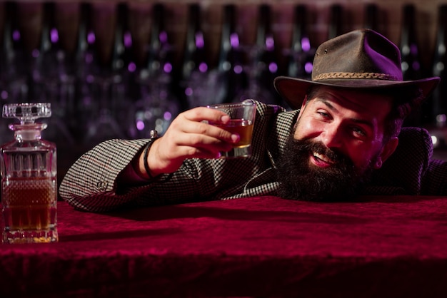 Hipster ivre barbu drôle émotionnel détient des acclamations de whisky en verre