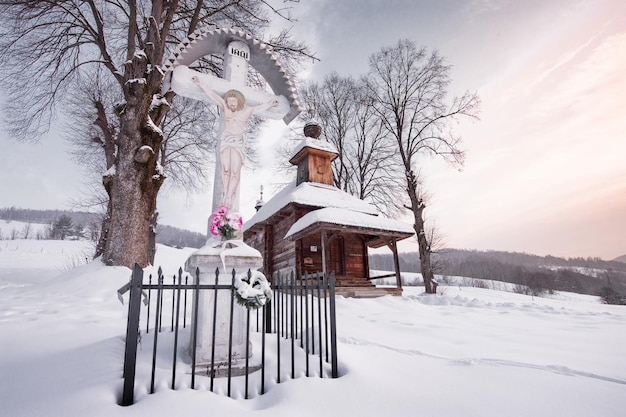 Photo hiver dans le village de jalova l'église catholique grecque en bois de saint-georges