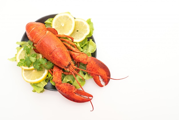 Photo homard fraîchement bouilli avec légumes et citron