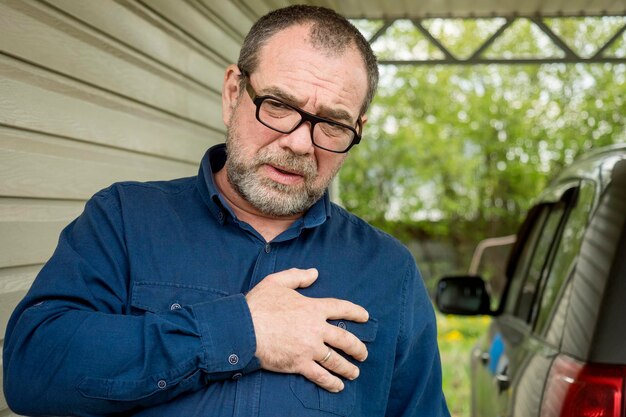 Photo un homme adulte tient sa main sur sa poitrine concept d'attaque cardiaque