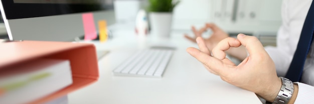 Homme d'affaires au bureau est assis à table dans une pose détendue