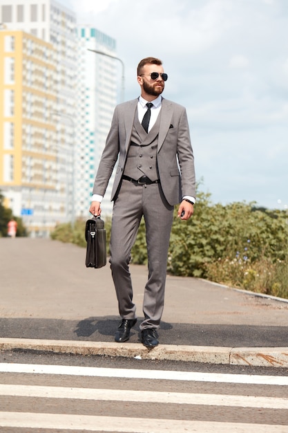 Homme d'affaires caucasien se rendre au bureau portant son sac de bureau