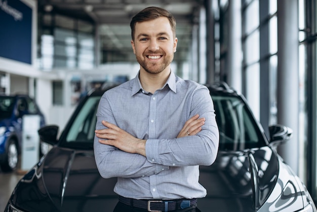 Homme d'affaires choisissant une voiture dans un salon de l'automobile