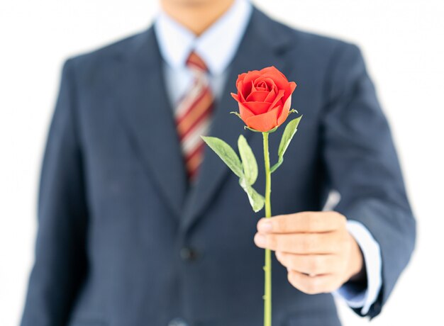 Homme d&#39;affaires en costume avec rose rouge sur blanc