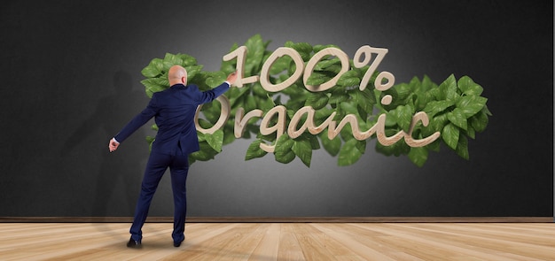 Homme d&#39;affaires devant un logo en bois 100% organique avec des feuilles autour du rendu 3d