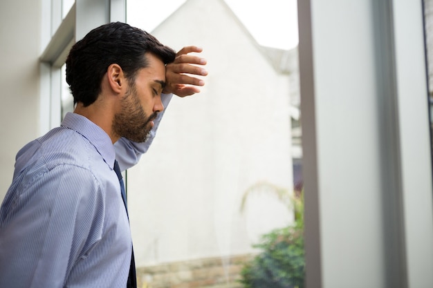 Homme d'affaires inquiet et stressé avec la main sur la tête au centre de conférence