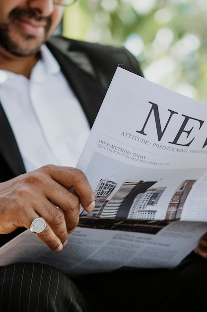 Homme d'affaires lisant un journal dans un café