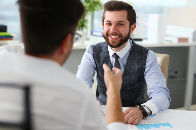 Un homme d'affaires souriant communique avec un partenaire de projet commercial