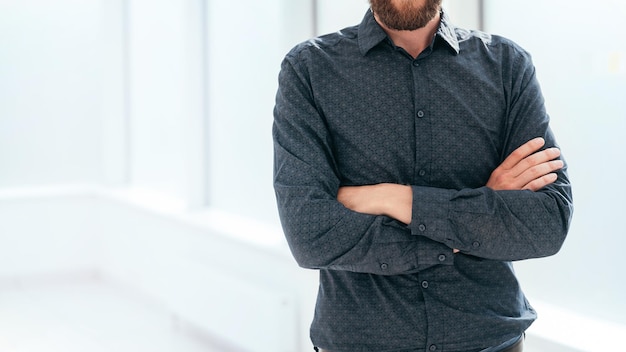 Homme d'affaires souriant debout près de la fenêtre du bureau. photo avec espace de copie