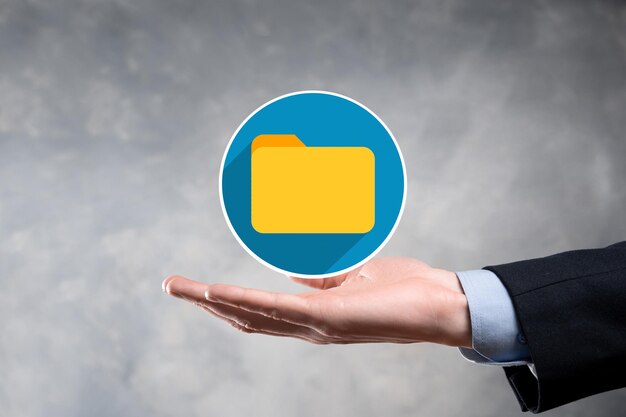 L'homme d'affaires tient l'icône du dossier Le système de gestion de documents ou la configuration DMS par un consultant informatique avec un ordinateur moderne recherchent la gestion des informations et des fichiers d'entrepriseTraitement d'entreprise