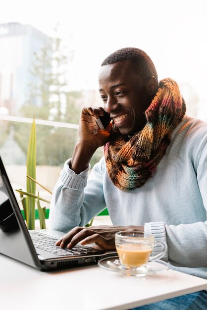 Homme d'affaires utilisant son ordinateur portable et son mobile dans le café. Concept d'entreprise.