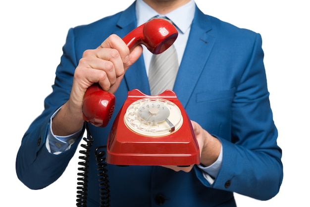 Homme d&#39;affaires en utilisant un téléphone vintage, isolé sur blanc