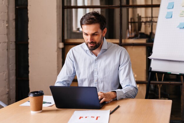 Homme d'affaires avec des vêtements de cérémonie travaillant au bureau