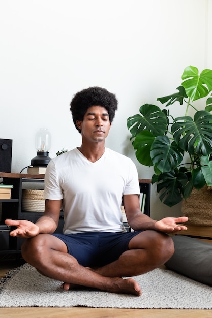 Un Homme Afro-américain Médite Dans Son Appartement Espace De Copie Image Verticale Méditationspiritualité