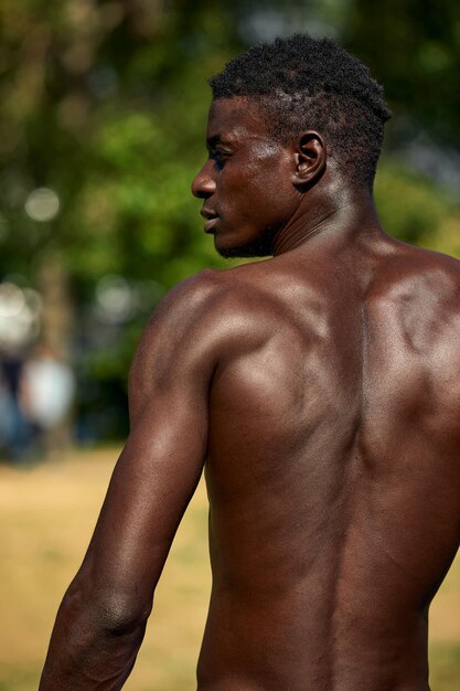 Homme afro-américain torse nu pendant l'entraînement, tiré de l'arrière