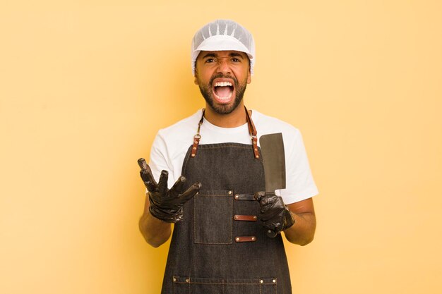 Homme afro cool à la recherche d'un concept de boucher agacé et frustré en colère