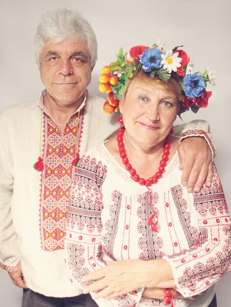 Un homme âgé embrasse une femme. Couple en costumes ukrainiens