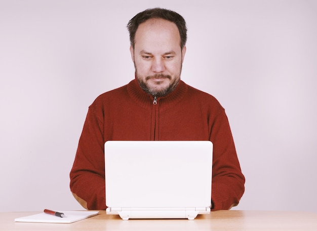 Photo homme d'âge moyen utilisant un ordinateur portable netbook pour rester connecté