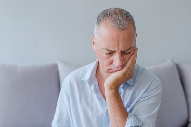 Homme d&#39;âge mûr souffrant de maux de dents, de caries