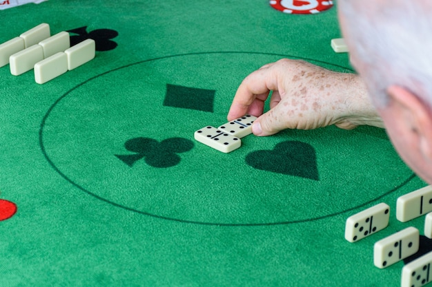 Un homme âgé qui lance un jeu de domino.