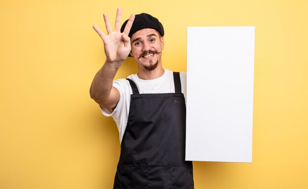 Homme d'artiste souriant et sympathique montrant le concept d'espace de copie numéro quatre