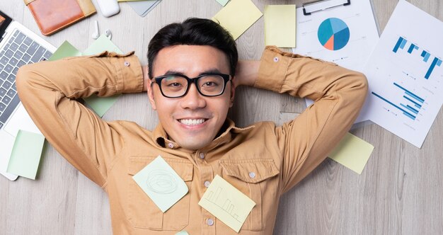 Un homme asiatique se sent heureux quand il termine son travail à temps