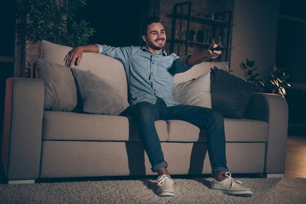 homme assis sur un canapé et regarder la télévision