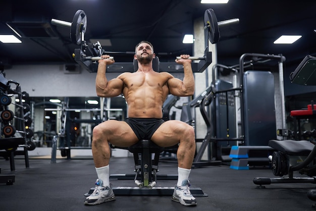 Photo un homme attrayant faisant de l'exercice avec un appareil d'entraînement au gymnase