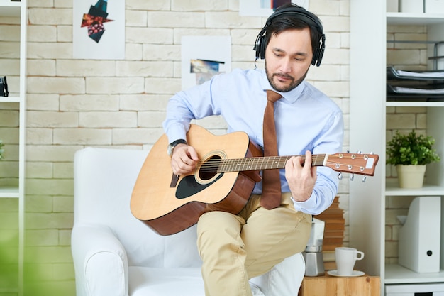 Homme au casque jouant de la guitare