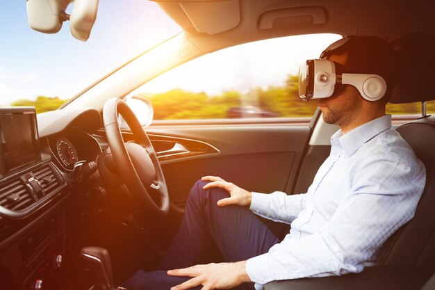 homme au volant portant un casque de réalité virtuelle