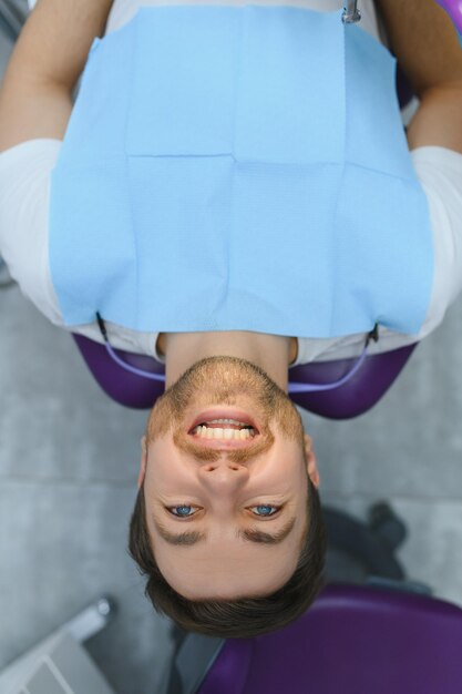 Photo homme ayant des dents examinées chez les dentistes