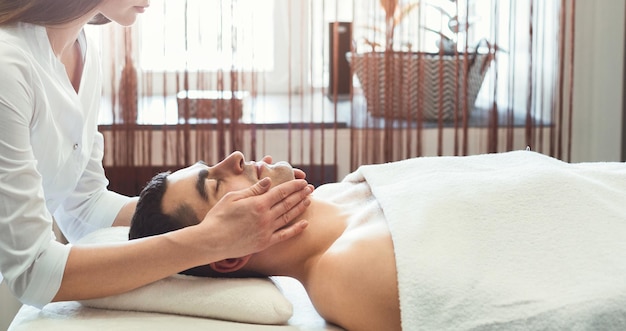 Homme ayant un massage professionnel de la tête dans un salon spa