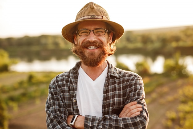 Homme barbu positif dans le paysage rural