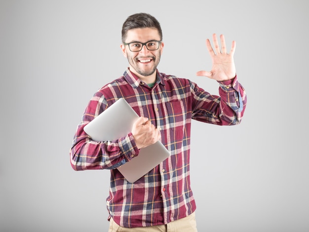 Homme barbu tenant un ordinateur portable