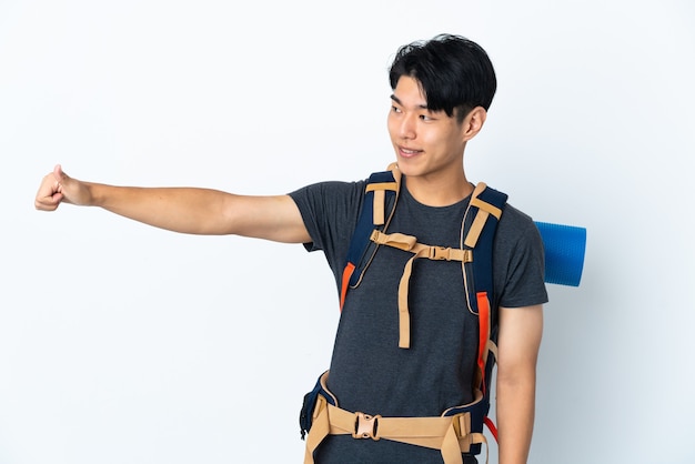Homme chinois alpiniste avec isolé sur mur blanc donnant un geste de pouce en l'air