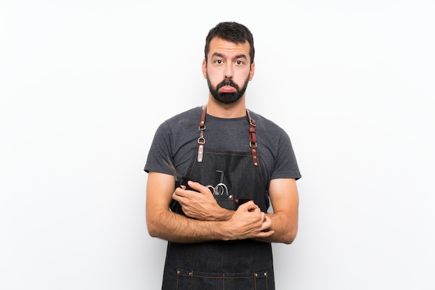 Homme de coiffeur dans un tablier avec une expression triste et déprimée