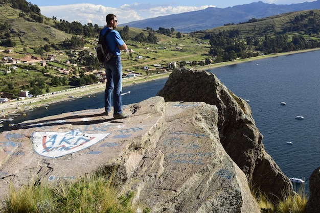 Un homme sur une colline regarde le paysage de Copacabana et du lac Titicaca Copacabana Bolivie