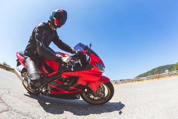 Homme conduisant une moto sur une route de campagne