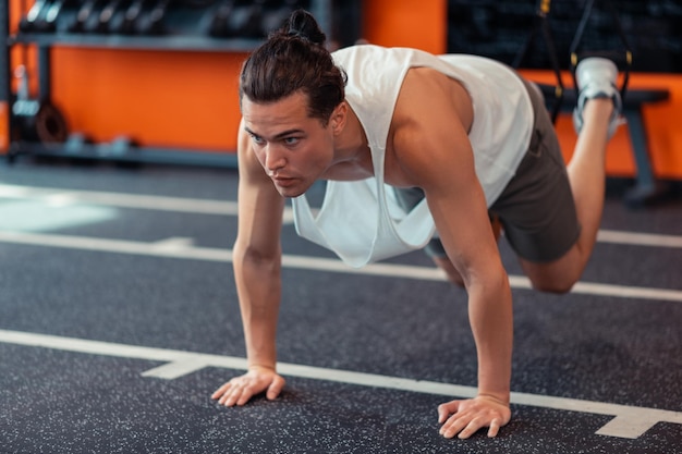 Homme confiant sérieux travaillant dur dans la salle de gym