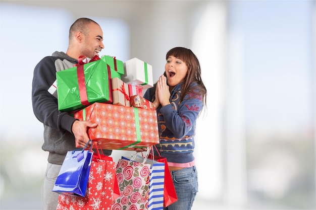 Un homme donne à une fille beaucoup de cadeaux en arrière-plan