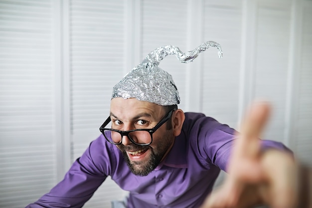 Homme drôle barbu dans un capuchon de papier d'aluminium. Phobies de l'art conceptuel. Théorie du complot. Conspiration. Folie.