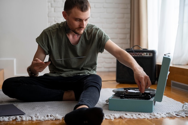 Photo homme écoutant de la musique à partir d'un disque vinyle